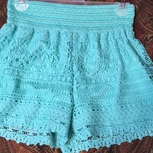 High rise turquoise lace embroidered shorts.